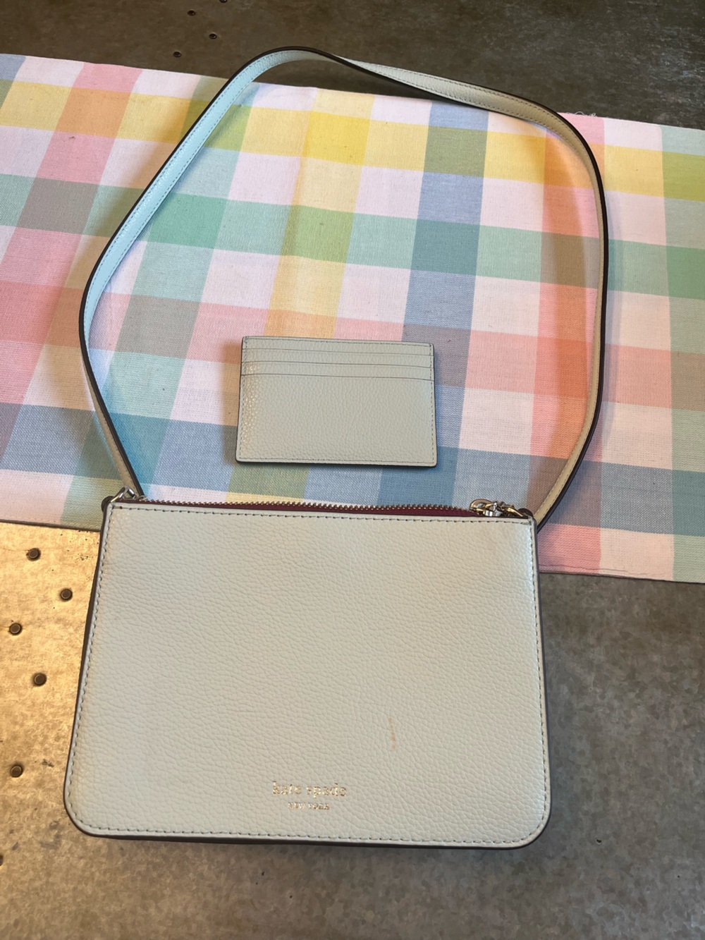 kate spade baby blue leather accessory with gold logo